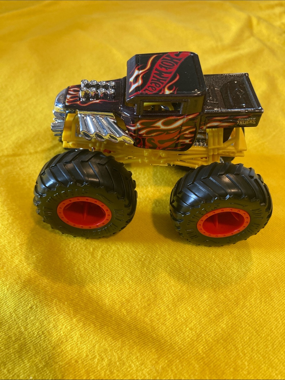 Hot wheels Black & Yellow Flame Monster Truck with Red Wheel Rims